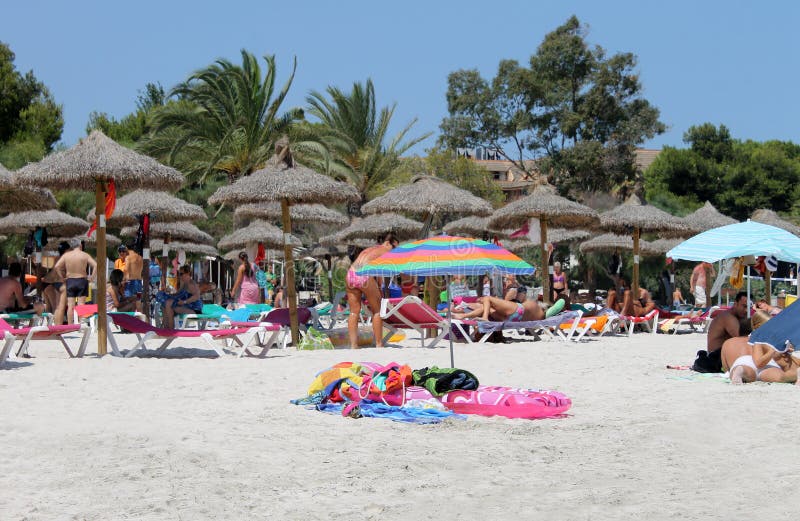 Women sunbathing on beach editorial stock photo. Image of sunbathers