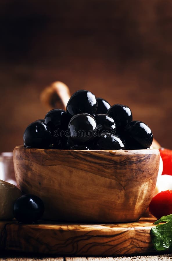 Spanish Black Olives in Olive Wooden Bowl, Rustic Kitchen Table