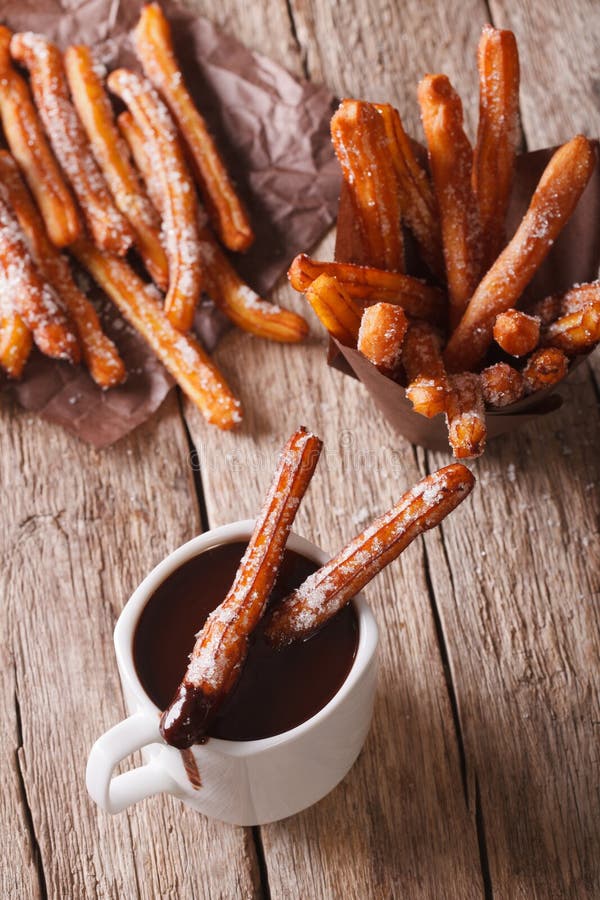 Spanish Cookies Churros Dipped in Chocolate. Vertical Top View Stock