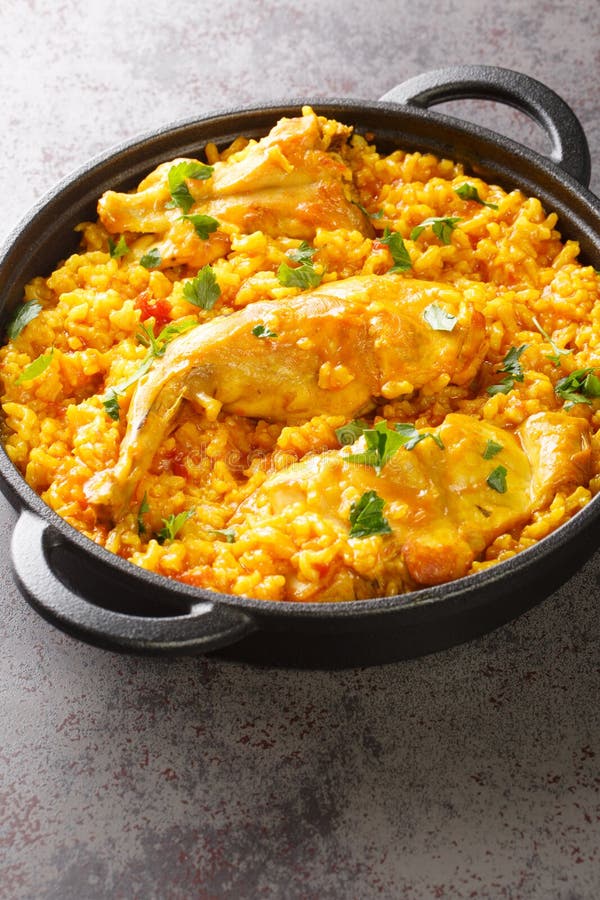 Spanish Paella with Rabbit Closeup in a Frying Pan. Vertical Stock