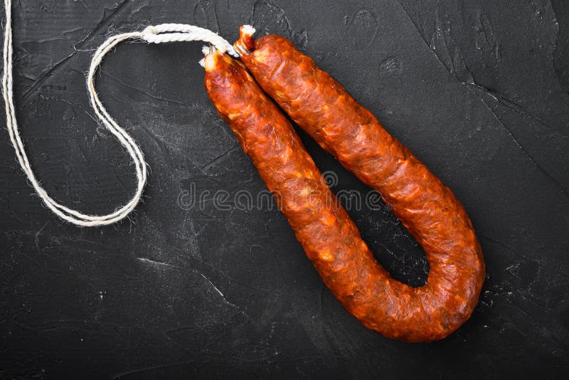 Spanish Pork Chorizo Sausages on Black Textured Background Stock Photo