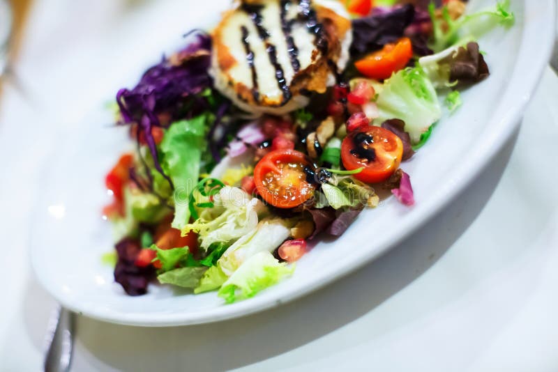 Spanish Vegetable Salad with Dressing on White Plate Stock Image