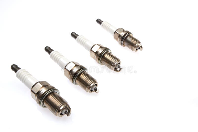 4 Spark Plugs with a Magnifying Glass Stock Image Image of assembly