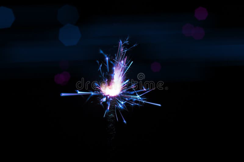 Sparkler in blue and white light on a black background stock photo Sparkler in blue and white light on a black background stock photo