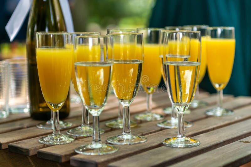 Sparkling Wine in Glasses with Orange Juice in Restaurant or on a Party Dinner Setting Stock