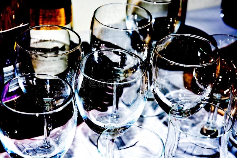 Sparkling wine glasses setup for party on a table closeup, filter treatment with high contrast.