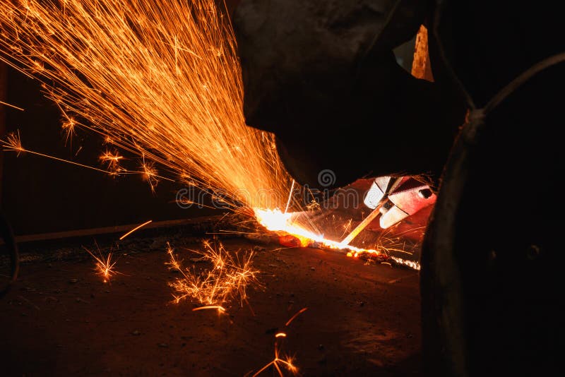 Sparks and smoke from Welder arc Gouging carbon electrode rods