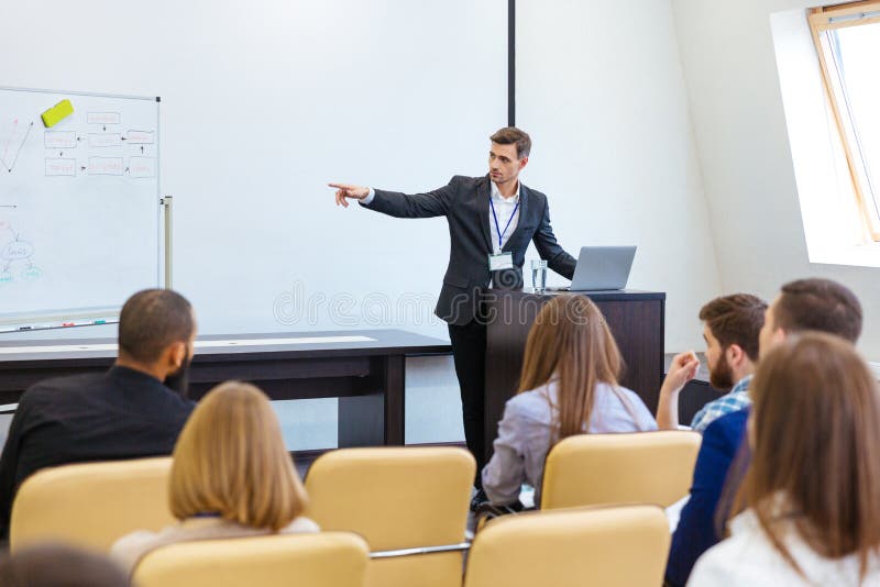 Speaker giving presentation at business conference stock photos