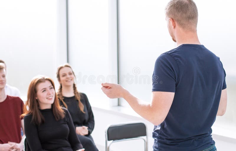 Speaker Makes a Report for a Group of Diverse Young People. Stock Image