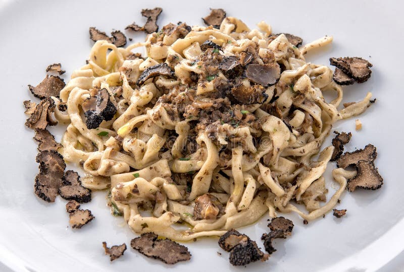 A plate of tasty homemade tagliatelle with truffles, orizontal photo and top view. A plate of tasty homemade tagliatelle with truffles, orizontal photo and top view