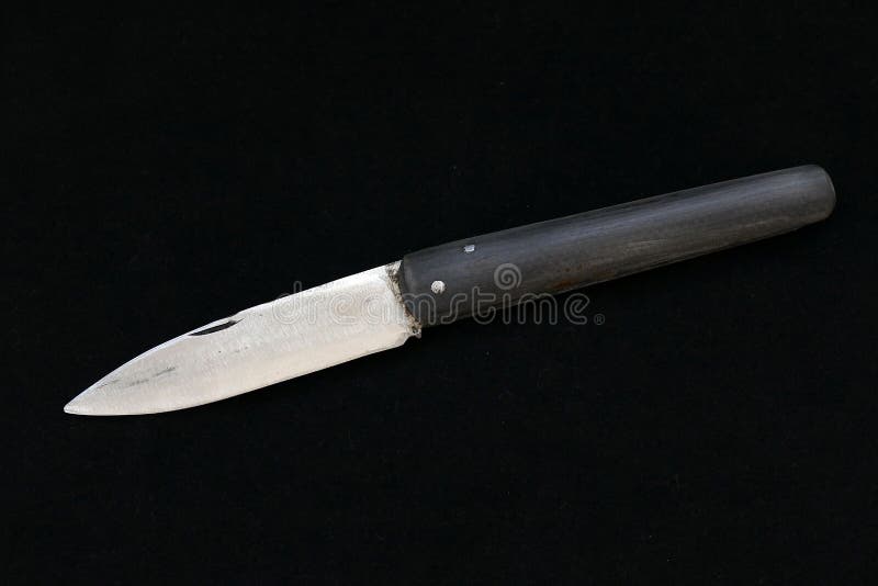 A Special Turkish Knife. Testing the Sharpness of the Blade on the Black Floor. a Small Pocket