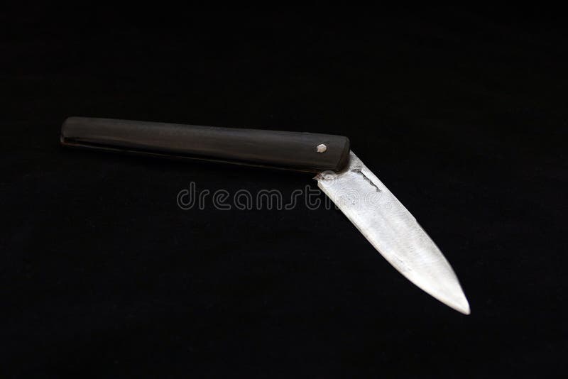 A Special Turkish Knife. Testing the Sharpness of the Blade on the Black Floor. a Small Pocket