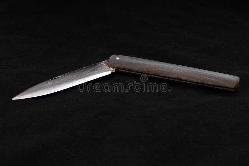 A Special Turkish Knife. Testing the Sharpness of the Blade on the Black Floor. a Small Pocket