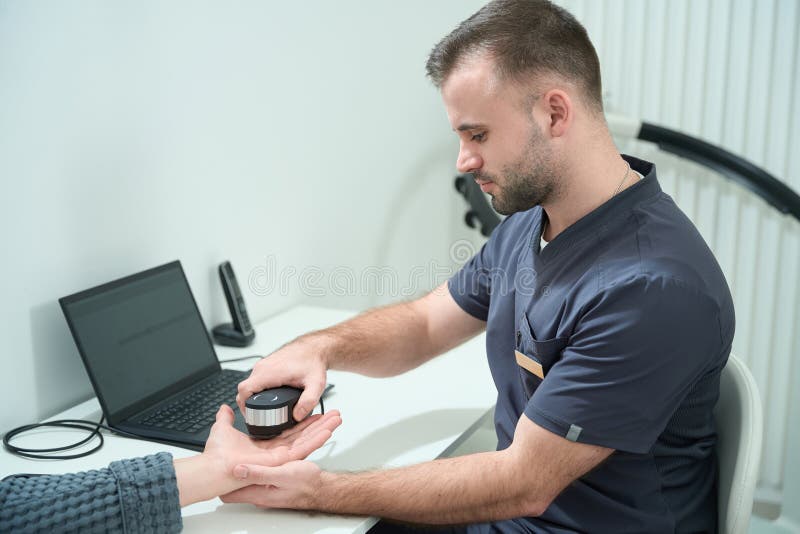 Specialist in a Medical Center Performs an Oligoscan Diagnostic