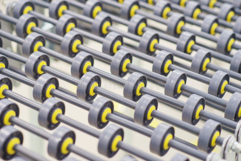Specialized conveyor line for the production of medical products consisting of many small rollers close-up.
