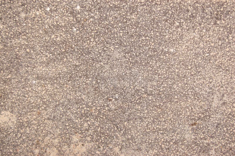 Speckled beige cement covered with fine spray of pale paint royalty free stock image