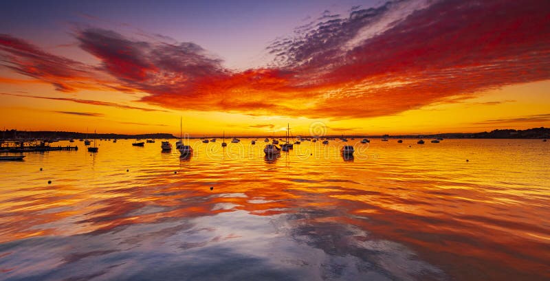Spectacular sunset over boats at Sandbanks, Poole Harbour, Dorset stock photography