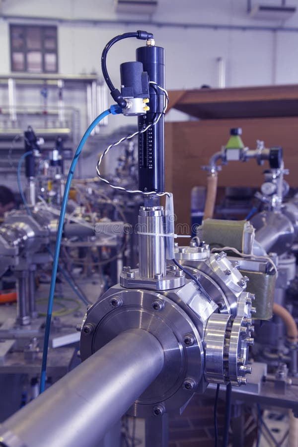 View of Important electronic and mechanical parts of Mass spectrometer in ION Accelerator command room, CNC machined parts, selective focus, tilt shift lens, industrial blue toned. View of Important electronic and mechanical parts of Mass spectrometer in ION Accelerator command room, CNC machined parts, selective focus, tilt shift lens, industrial blue toned