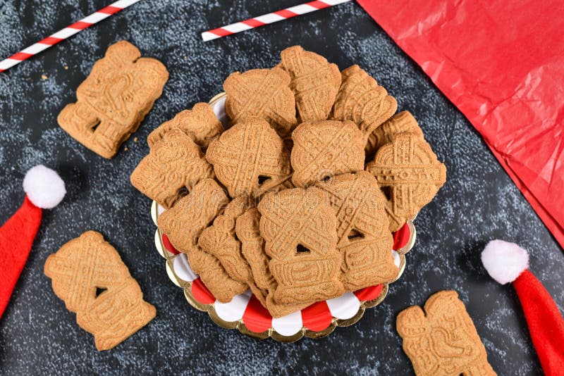 `Speculaas` or `speculoos`, a spiced thin, crunchy and caramelizedand shortcrust biscuit with figure stamped on the front side, traditionally baked in Europe in Christmas season. `Speculaas` or `speculoos`, a spiced thin, crunchy and caramelizedand shortcrust biscuit with figure stamped on the front side, traditionally baked in Europe in Christmas season