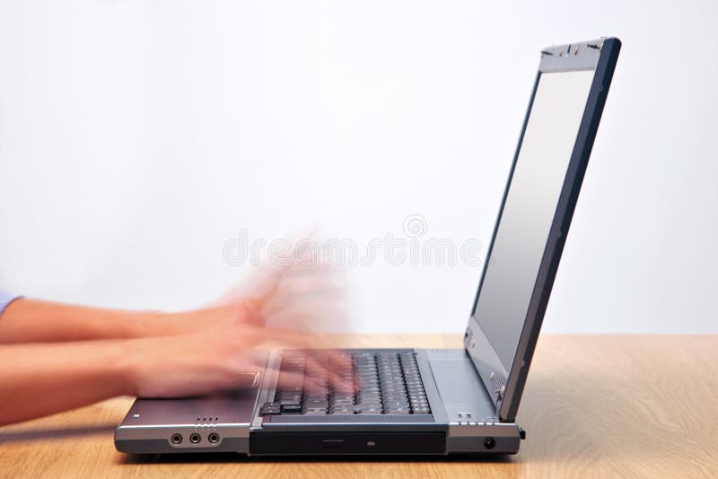 Speed typing. A woman hands typing on a laptop computer keyboard with motion blur to emphasise the speed. Blank screen to add your own message Speed typing. A woman hands typing on a laptop computer keyboard with motion blur to emphasise the speed. Blank screen to add your own message