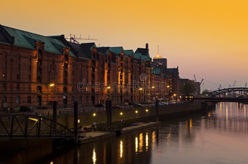 Hamburg Speicherstadt brick buildings in pink orange evening light. Hamburg Speicherstadt brick buildings in pink orange evening light