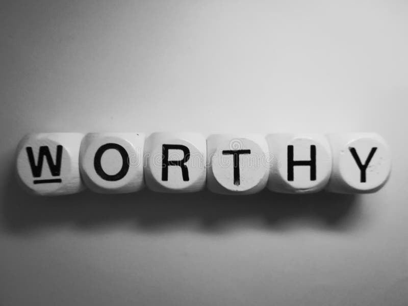 Word worthy spelled on wooden dice