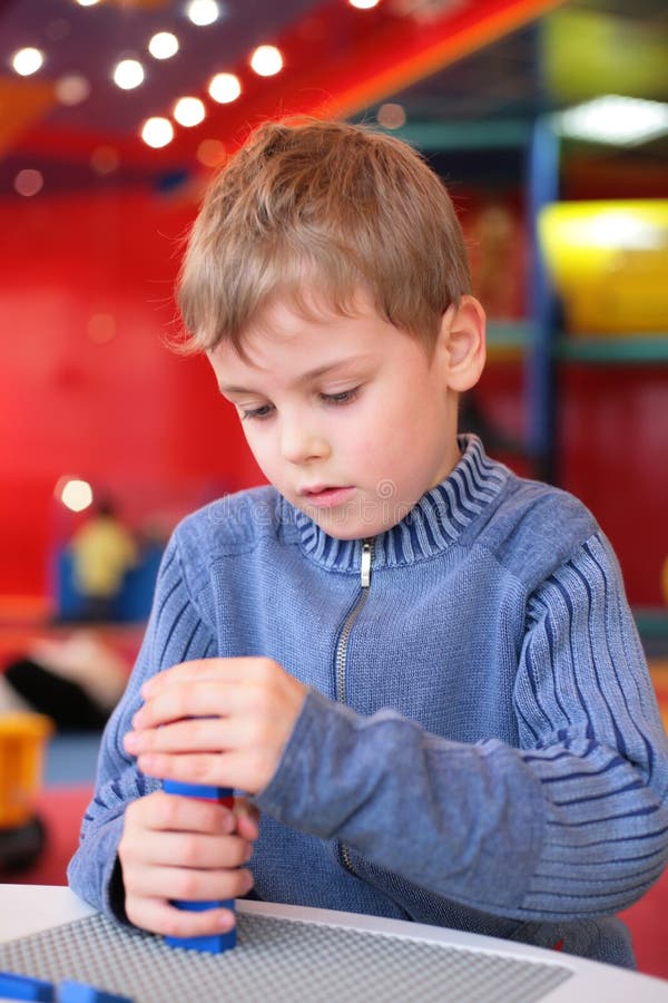 Boy plays with plastic constructor in kindergarten. Boy plays with plastic constructor in kindergarten