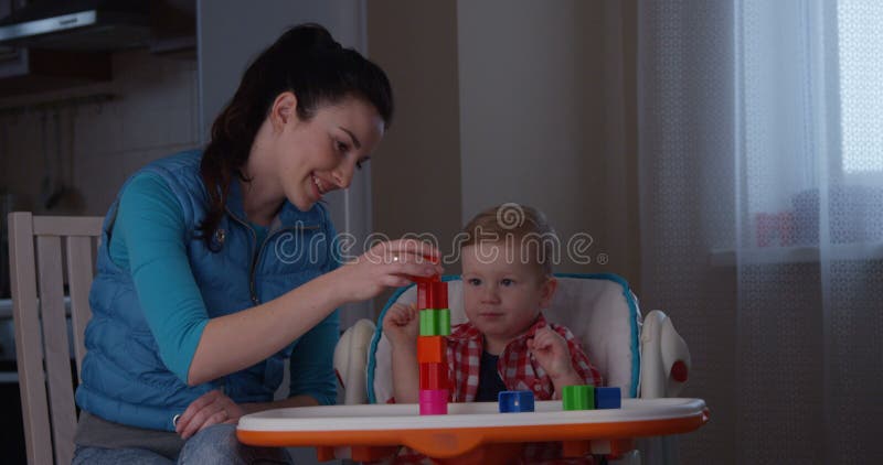 Spending family time mother with baby and developing fine motor skills using games