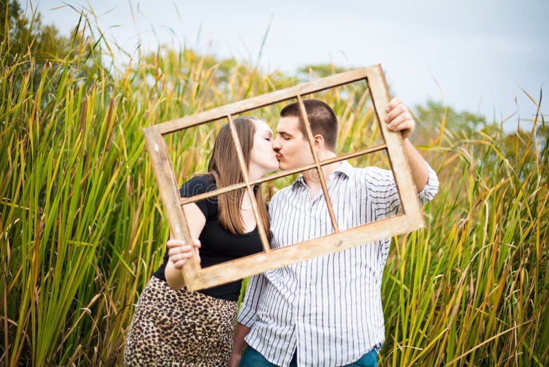 A young couple kissing picturing their future together. A young couple kissing picturing their future together.