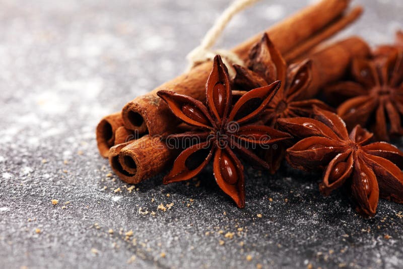 Spezie di inverno dell'anice stellato e della cannella su fondo rustico immagini stock Spezie di inverno dell'anice stellato e della cannella su fondo rustico immagini stock