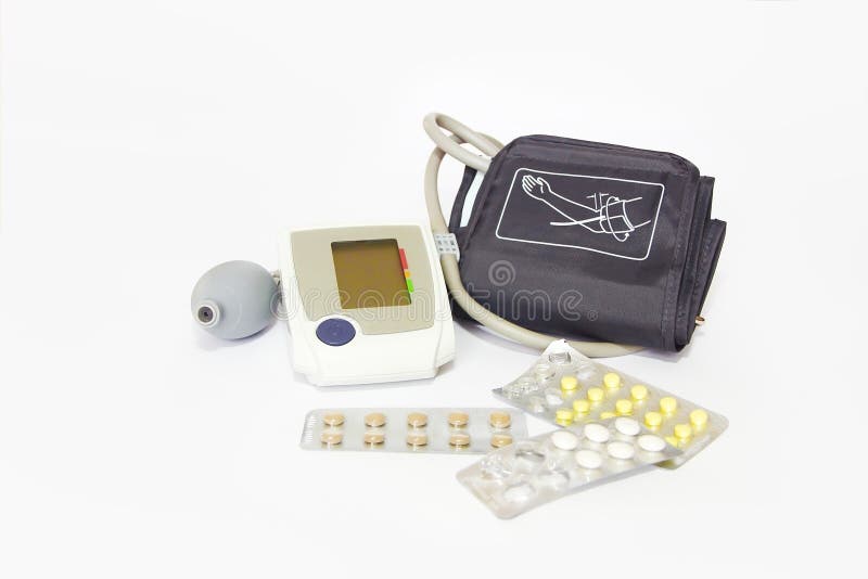 Sphygmomanometer medical tonometer and multi-colored pills on white background stock photo