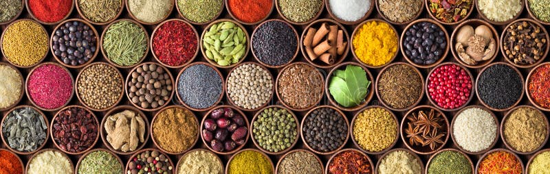 Different seasonings in cups. Spice background on the table