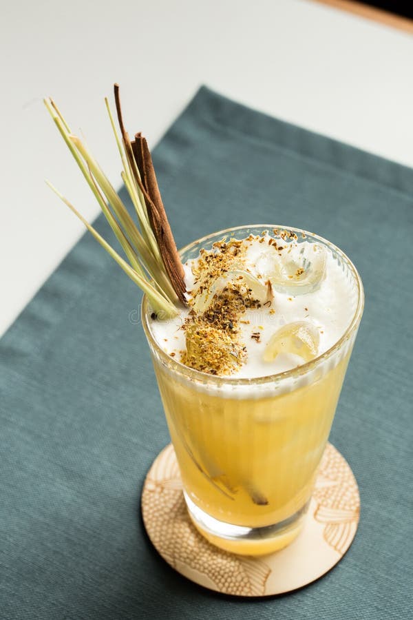 Spiced Apple Cider Rum Punch Cocktail Tall Glass on the Table at