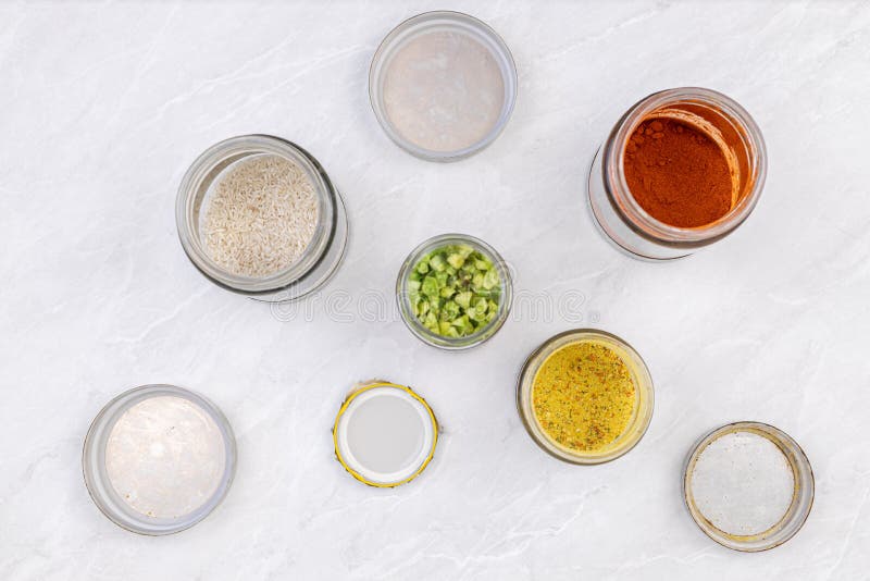 Spices and Groceries in Jars on the Grey Marble Kitchen Table. Home