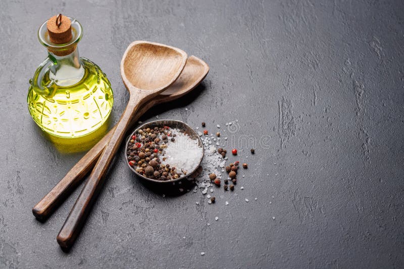Spices, olive oil, and utensils on cooking table stock images