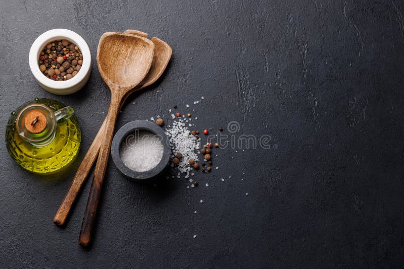 Spices, olive oil, and utensils on cooking table royalty free stock photography
