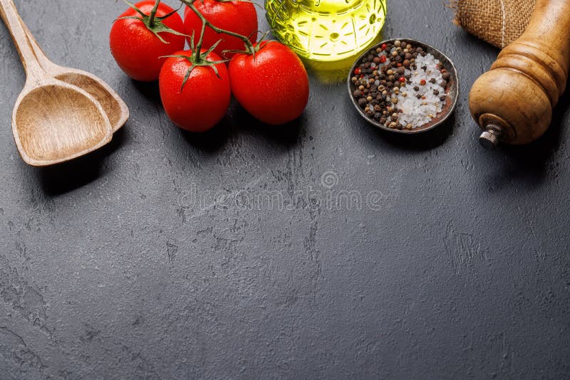 Spices, olive oil, and utensils on cooking table royalty free stock image
