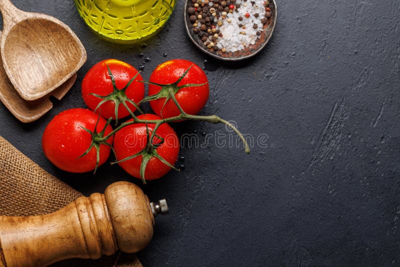 Spices, olive oil, and utensils on cooking table stock photo