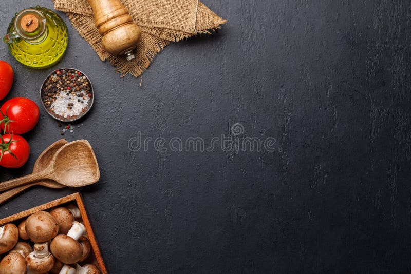 Spices, olive oil, and utensils on cooking table royalty free stock image