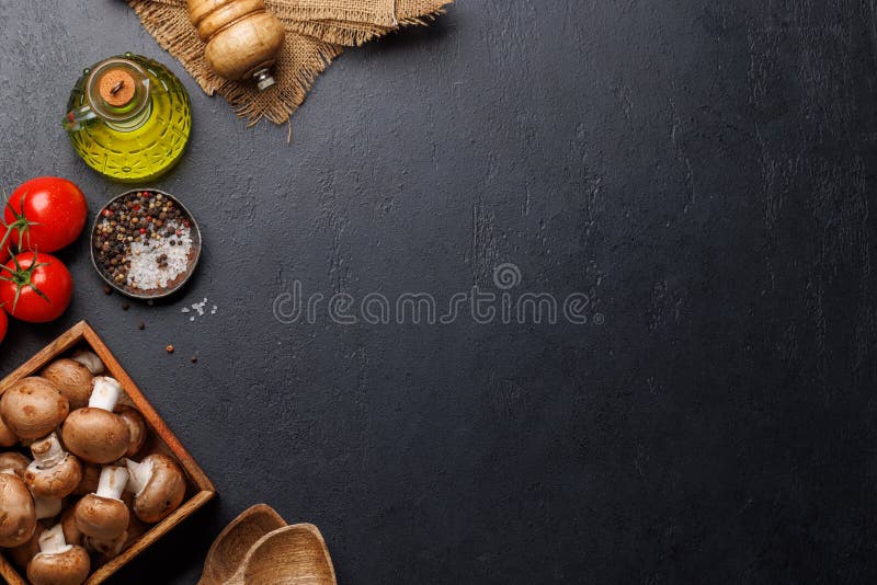 Spices, olive oil, and utensils on cooking table royalty free stock photo