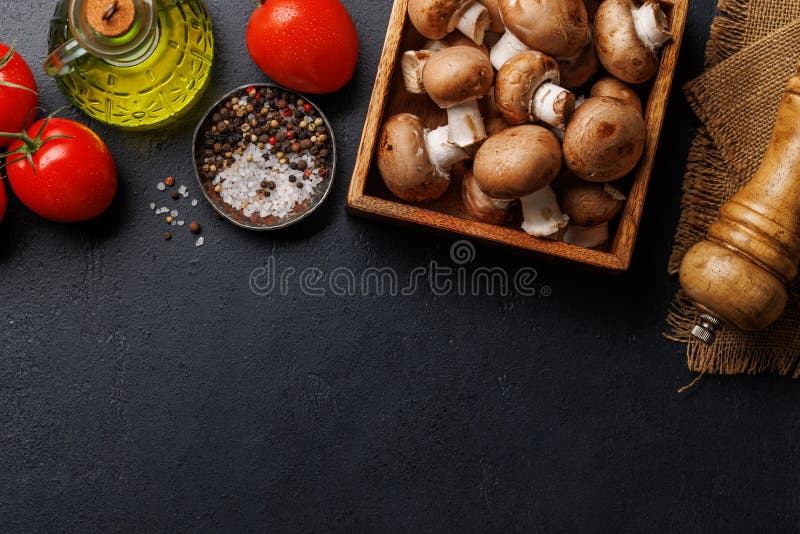 Spices, olive oil, and utensils on cooking table royalty free stock photo
