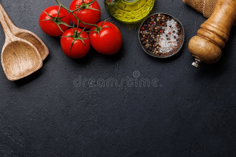 Spices, olive oil, and utensils on cooking table royalty free stock photography