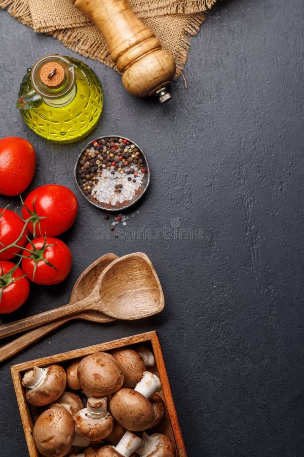Spices, olive oil, and utensils on cooking table royalty free stock photo