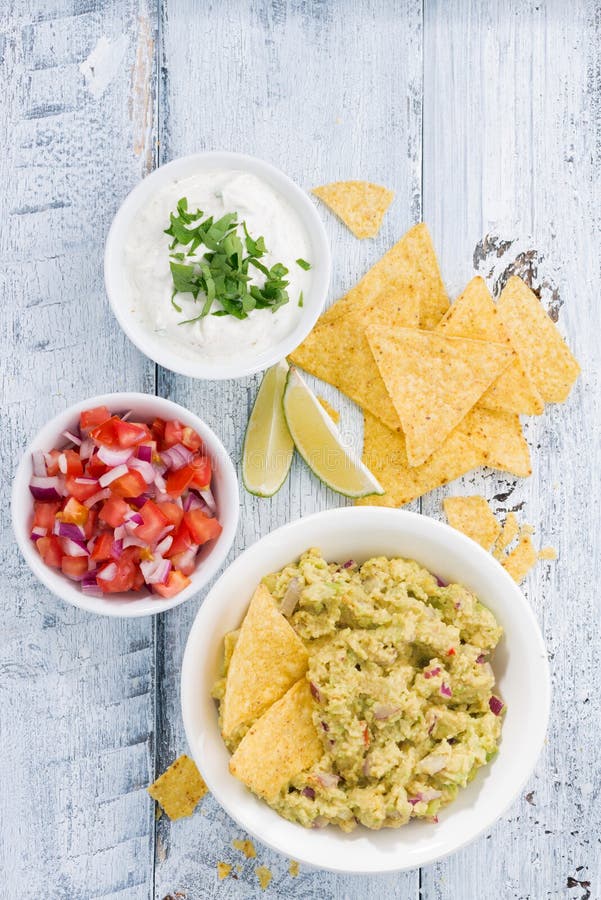 Spicy Avocado Sauce and Assorted Sauces with Corn Chips Stock Image