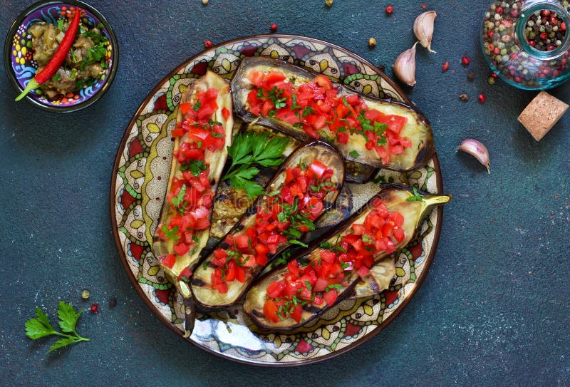 Spicy Baked Eggplant Grilled with Tomatoes and Peppers. Stock Photo Image of cooked,