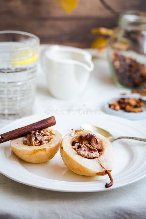 Spicy baked pear with walnuts, honey, cinnamon sticks, healthy d