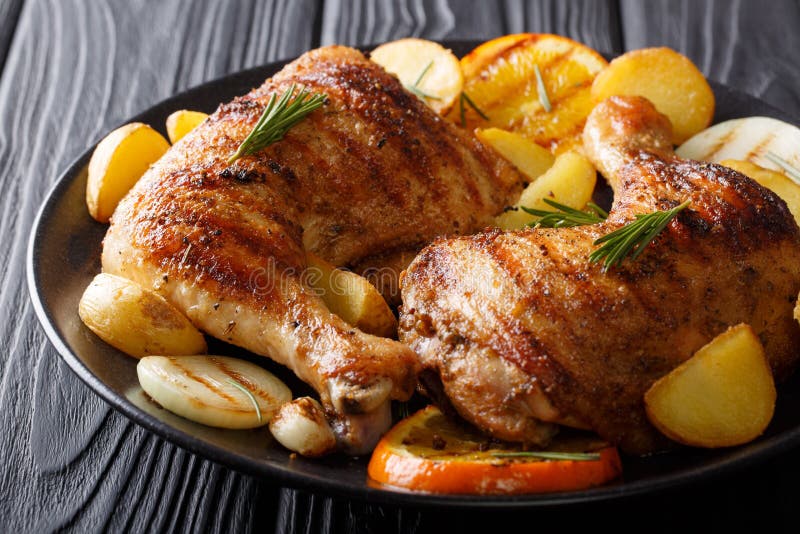 Spicy bbq chicken legs with grilled oranges, onions, garlic and royalty free stock photo Spicy bbq chicken legs with grilled oranges, onions, garlic and royalty free stock photo