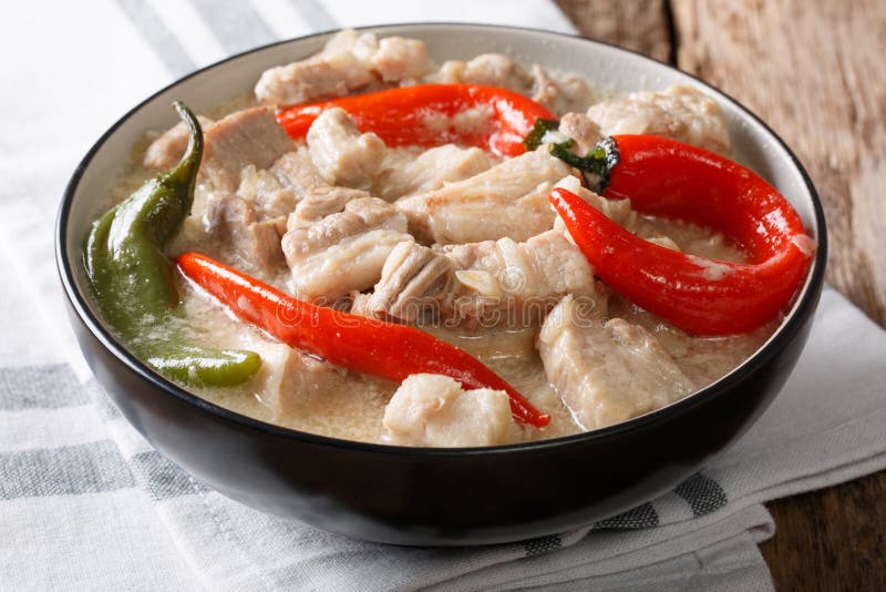 Spicy Bicol Express with chili, coconut, garlic, onion and ginger close-up in a bowl. horizontal