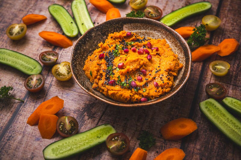 Spicy carrot hummus with raw vegetable sticks. Paleo cauliflower stock images, royalty-free photos and pictures