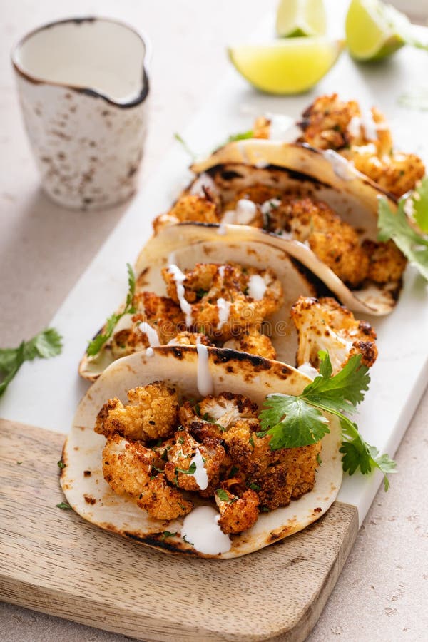 Spicy Cauliflower Tacos With Cilantro And Mexican Crema Stock Image spicy-cauliflower-tacos-with-cilantro-and-mexican-crema-stock-image